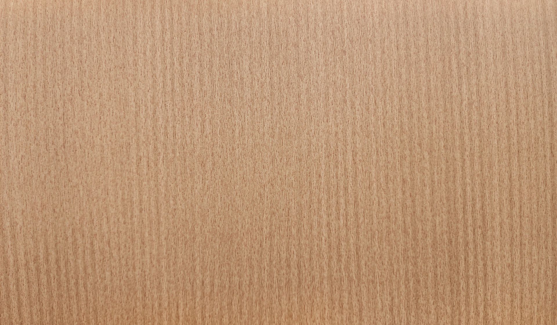 Close-up of light brown, vertically-grained wood surface.