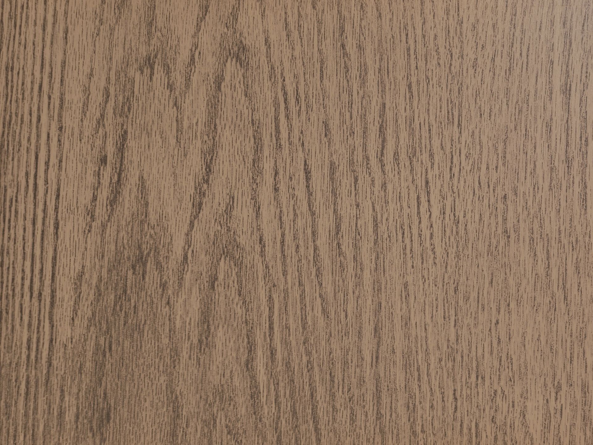 Close-up of wood grain texture in shades of brown and tan.