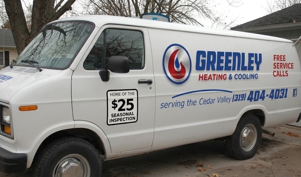 A white Greenley Heating & Cooling service van parked outside.