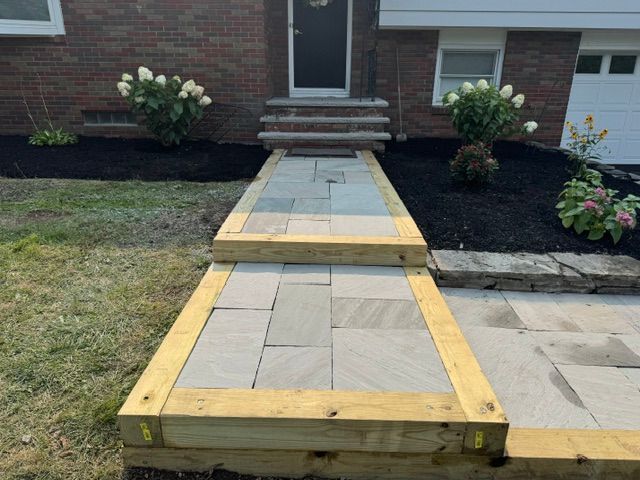 Temporary wooden ramp over front walkway leading to a brick house entrance