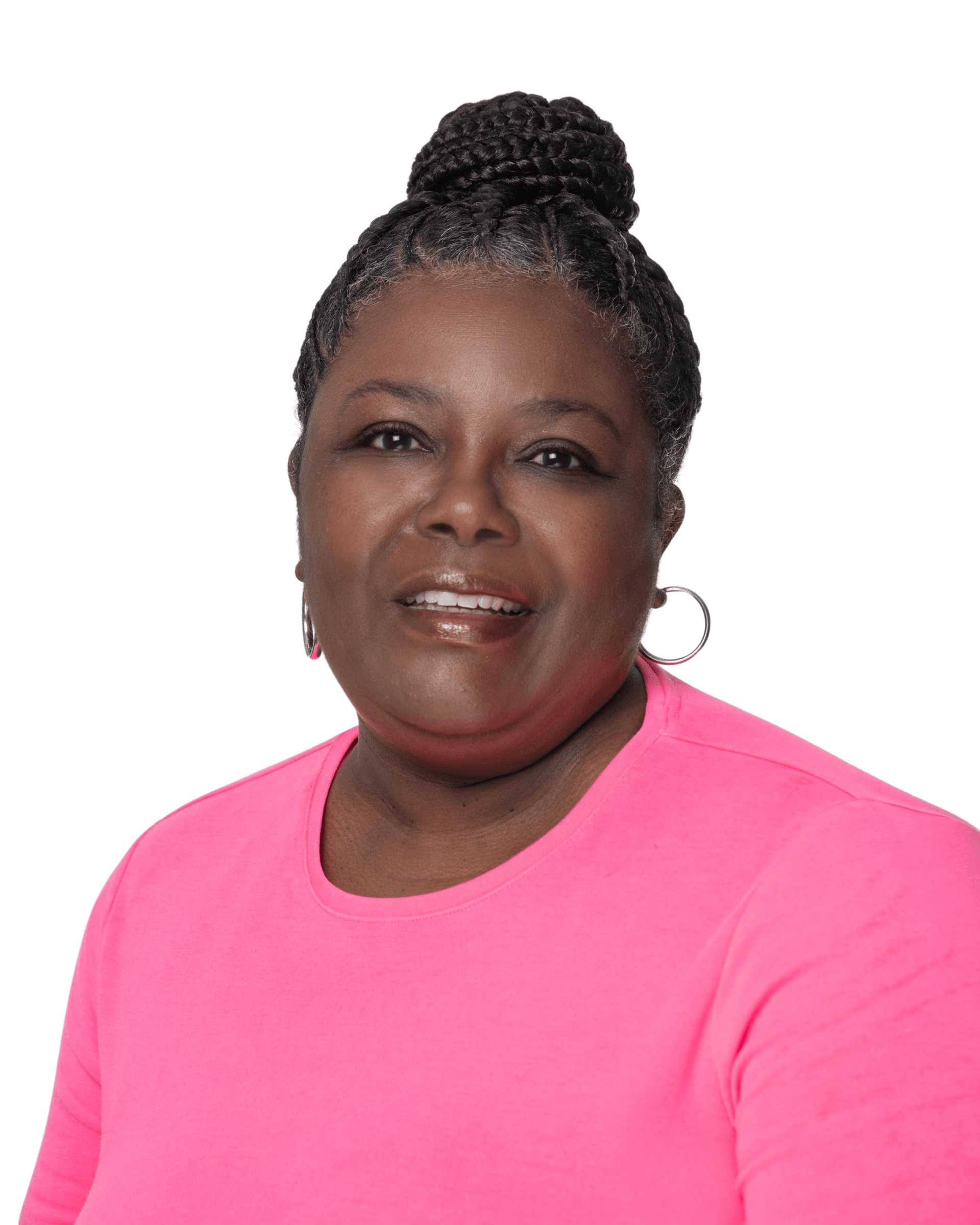 A woman in a pink shirt is smiling for the camera.