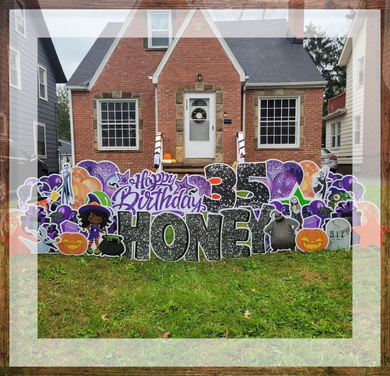 A birthday sign for honey is in front of a brick house