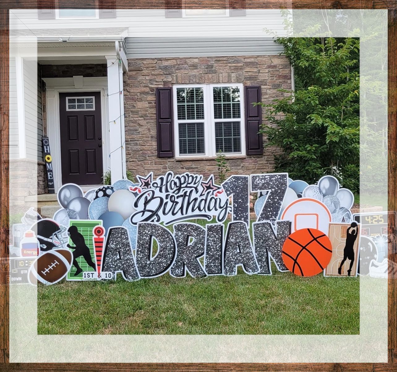 A birthday sign for adrian is in front of a house.