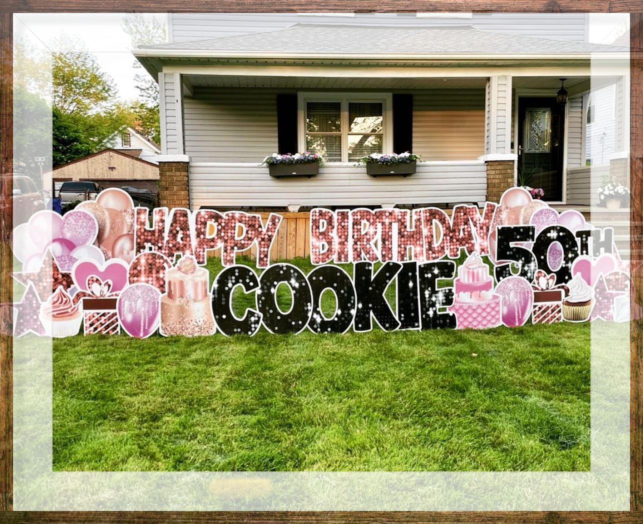 A birthday sign in front of a house that says `` happy birthday cookie ''.