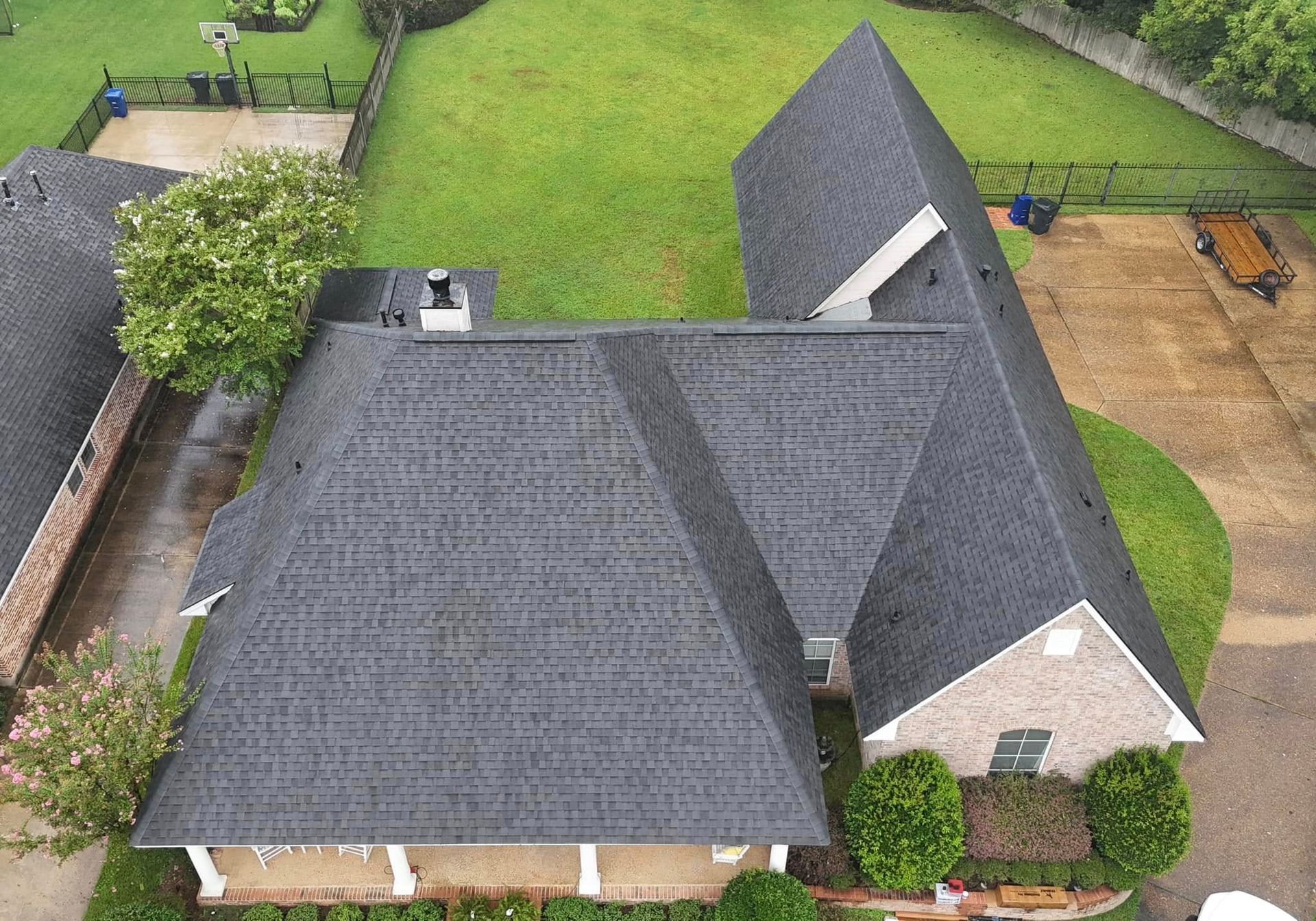 An aerial view of a house with a roof that is covered in shingles.