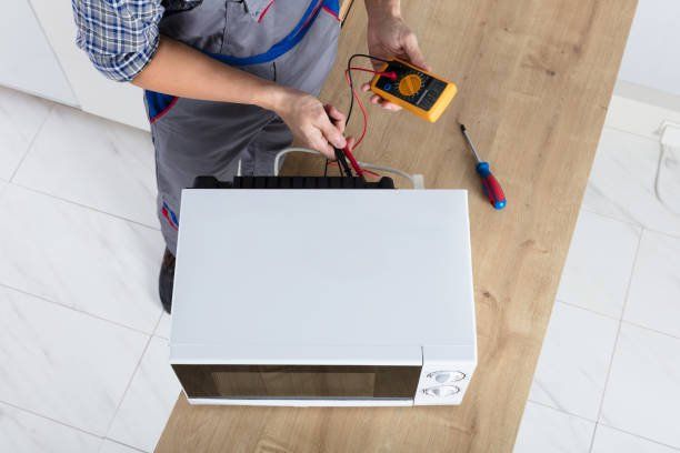 Technician checking microwave