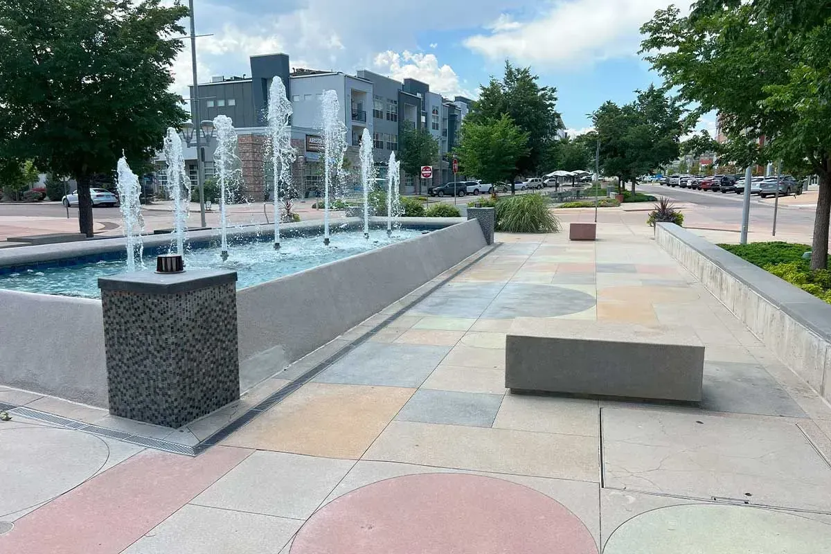 Stamped decorative concrete plaza with water fountain.