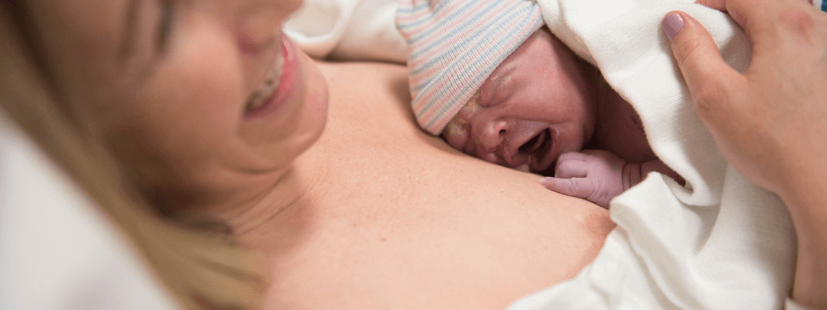 Newborn baby on mother’s chest after birth in a South West London maternity hospital