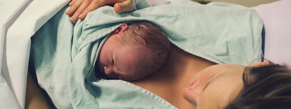 Newborn baby held skin-to-skin after birth at a birth centre in South West London