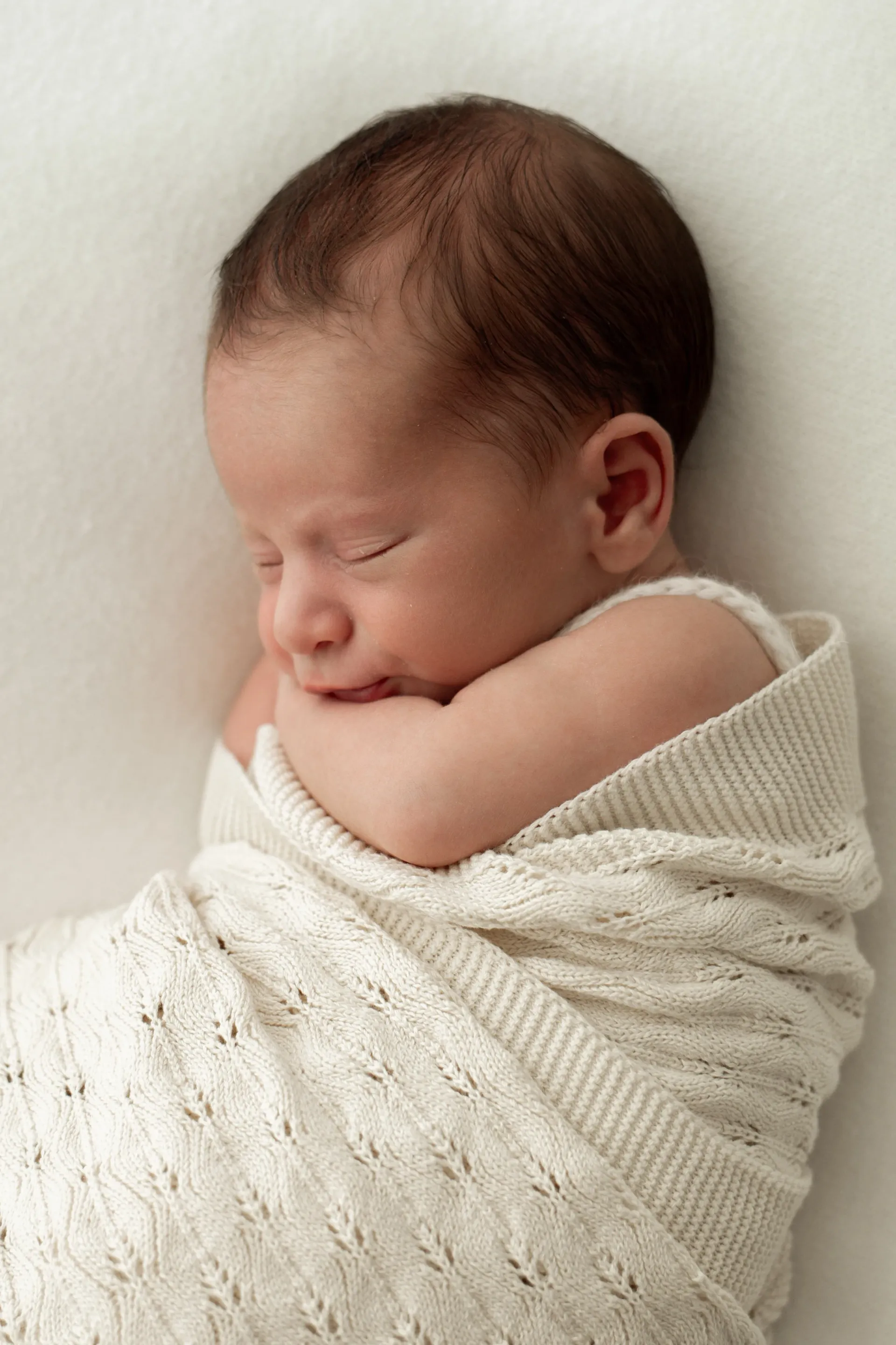 Newborn baby portraits with gentle, natural styling near Wimbledon