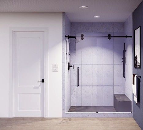 A modern bathroom featuring a white door beside a walk-in shower with matte black fixtures, glass sliding doors, and a bench.