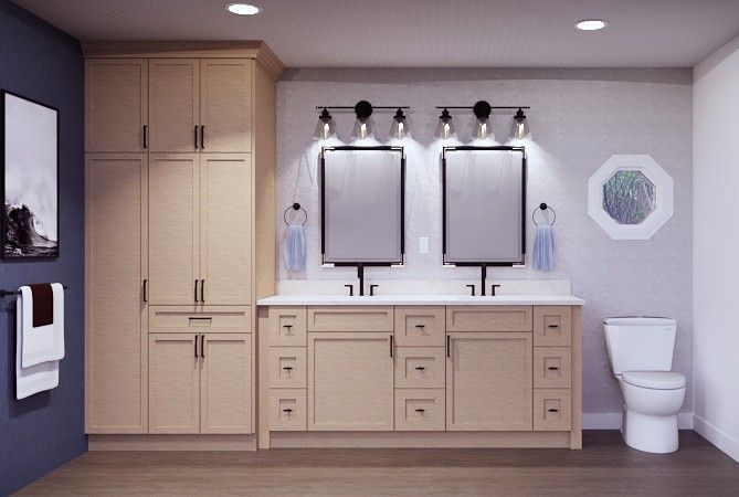Modern bathroom featuring a double vanity with light wood cabinets, two mirrors, wall lighting, and a white toilet.