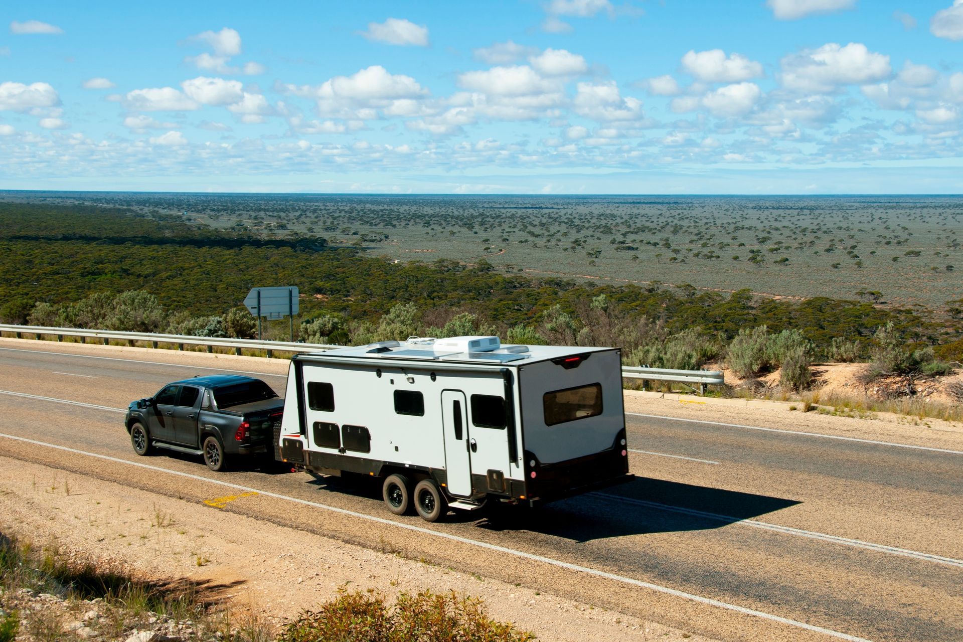 A Ute towing a Caravan on an Open Road — Waring's Auto Electrical in South Geelong, VIC