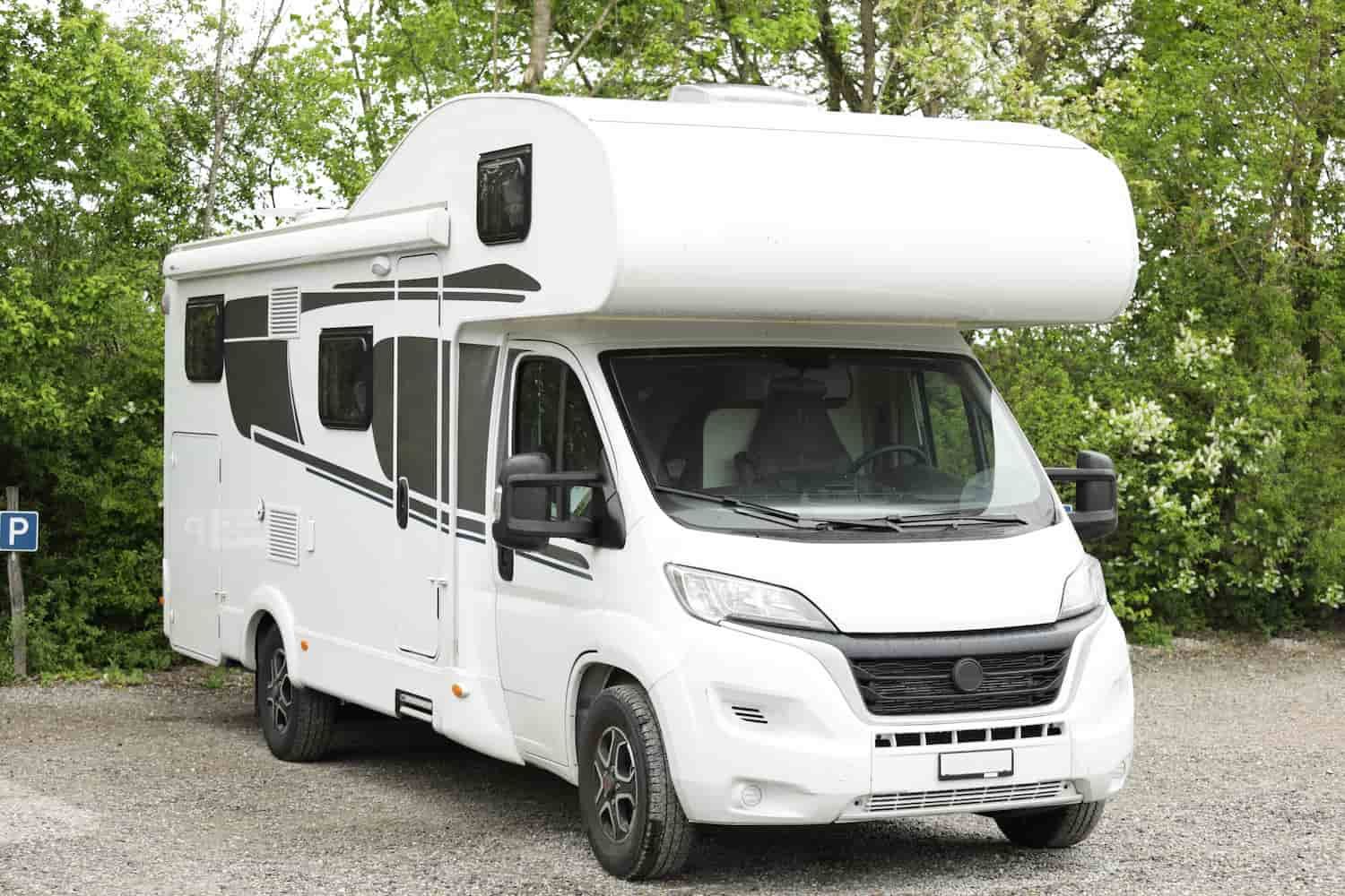 A White RV is Parked in a Gravel Lot — Waring's Auto Electrical in South Geelong, VIC