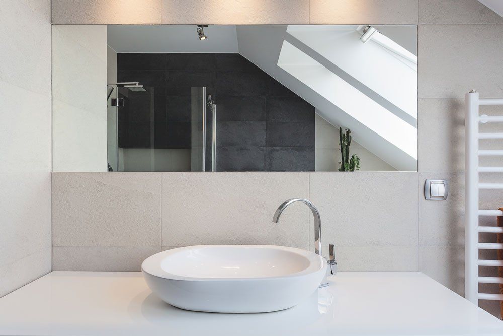 a bathroom with a sink and a large mirror .