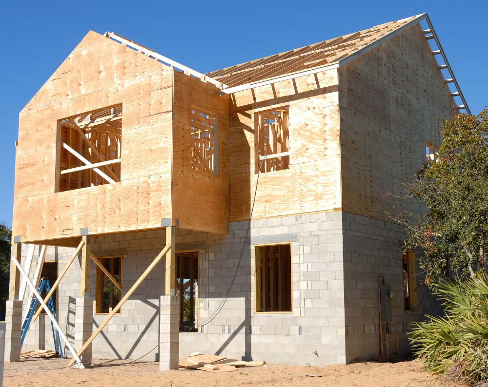 a house that is being built with a blue sky in the background