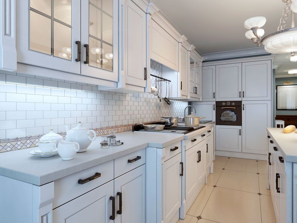 a kitchen with white cabinets and a white counter top .