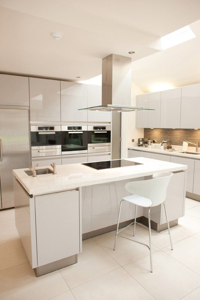 a kitchen with white cabinets and stainless steel appliances