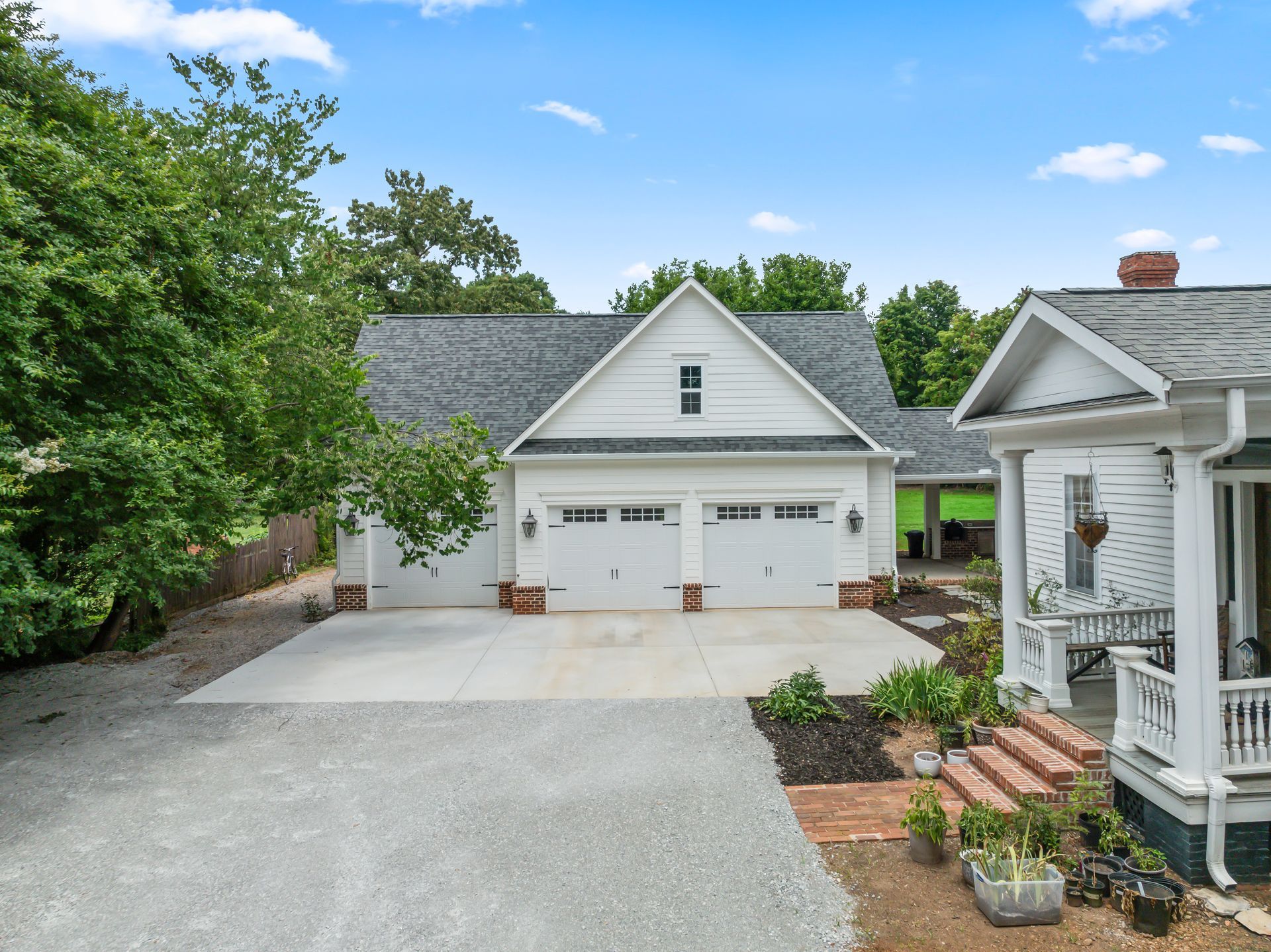 A white house with a garage and a porch