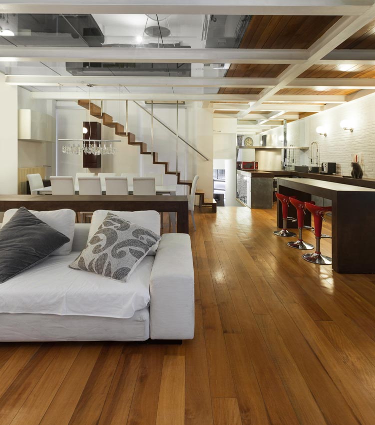 a living room with hardwood floors and a white couch