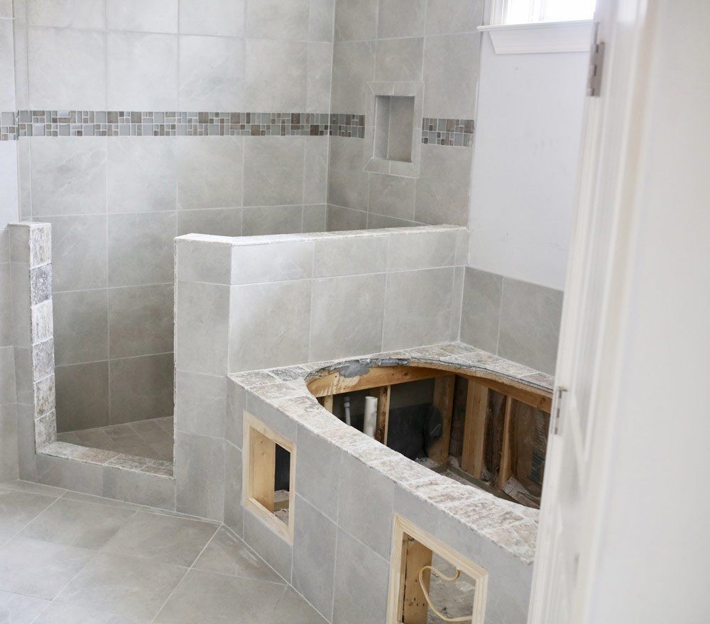 a bathroom with a bathtub and shower under construction