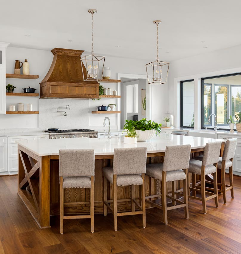 a kitchen with a large island and stools