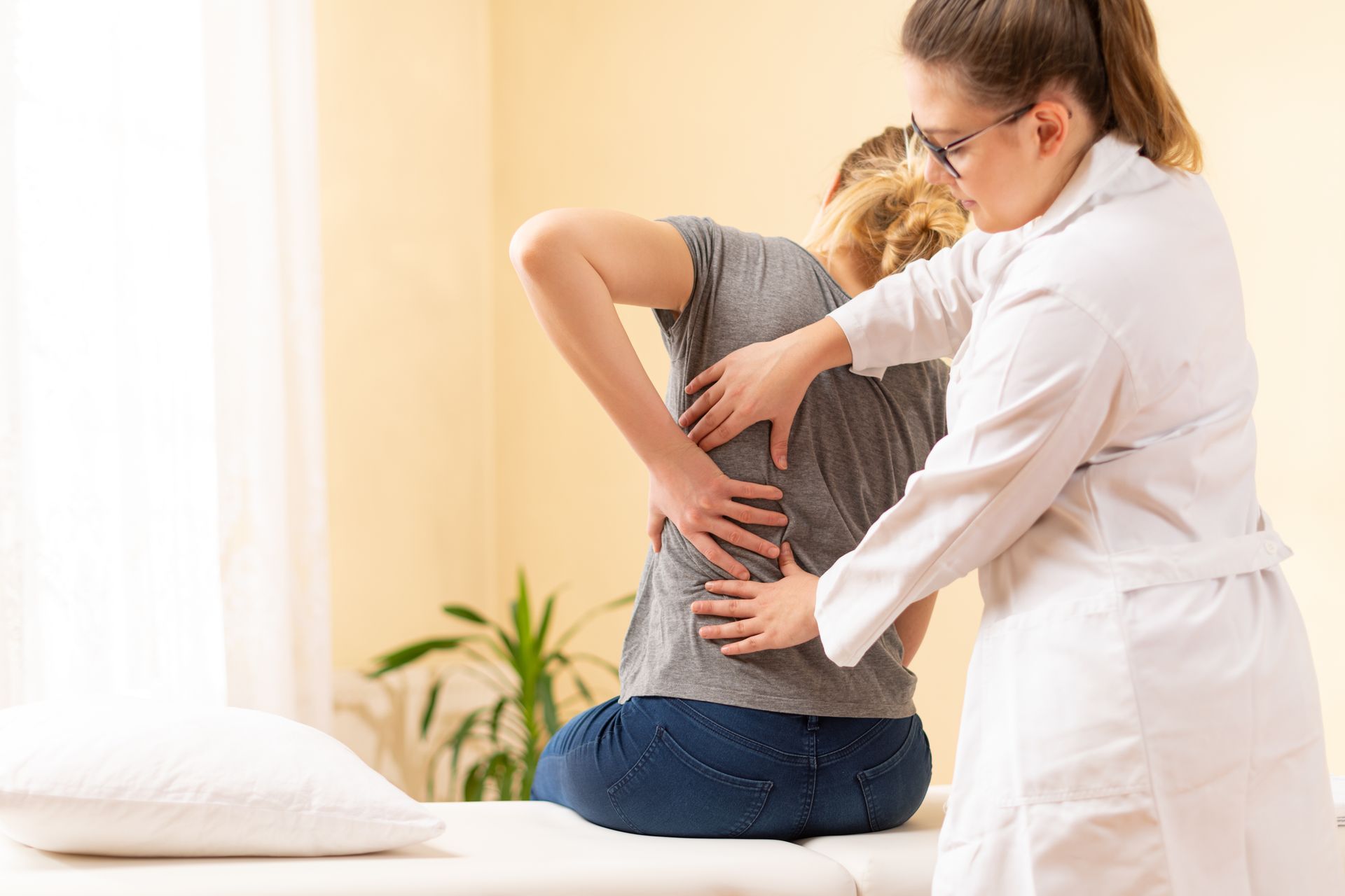 A skilled chiropractor performs a spinal adjustment to relieve back pain for a patient. A skilled chiropractor performs a spinal adjustment to relieve back pain for a patient.
