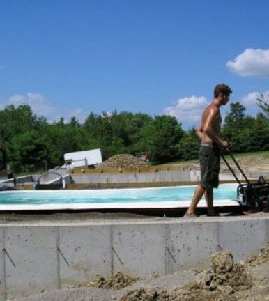 Worker cleaning the backyard pool