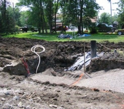 Construction in backyard with large excavation pit