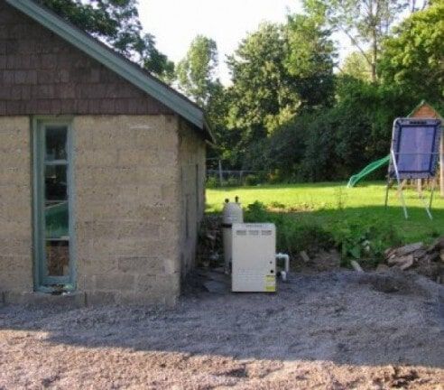 Backyard beside a shed with a white generator