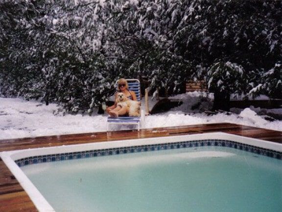 Snowy backyard pool with turquoise water