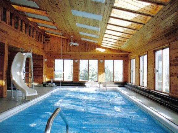 Indoor swimming pool in a wood-paneled room