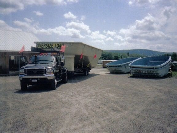 Truck parked near the two pool container