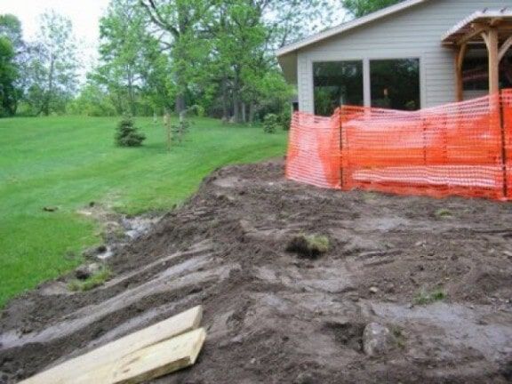 Mud and soil piled beside a house