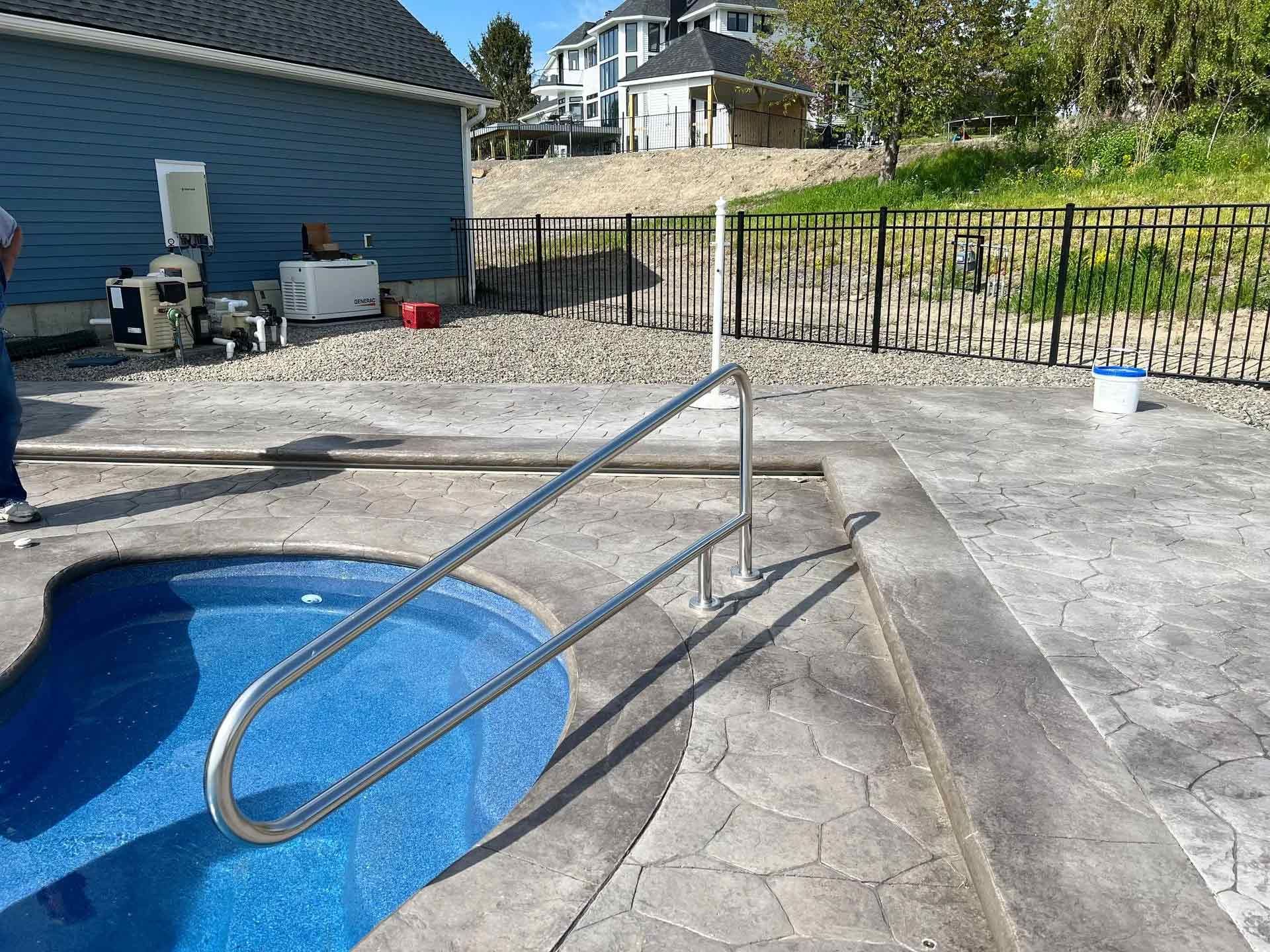 Backyard pool with metal handrail