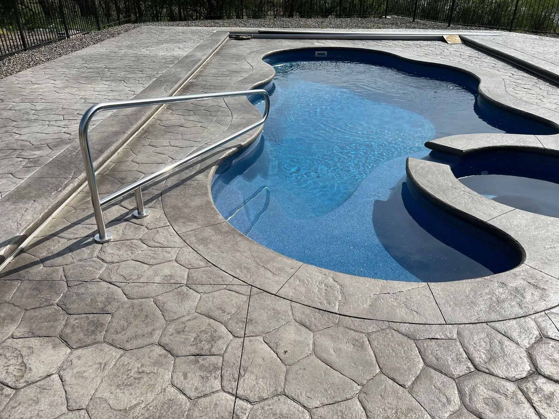 Curved backyard pool with blue water
