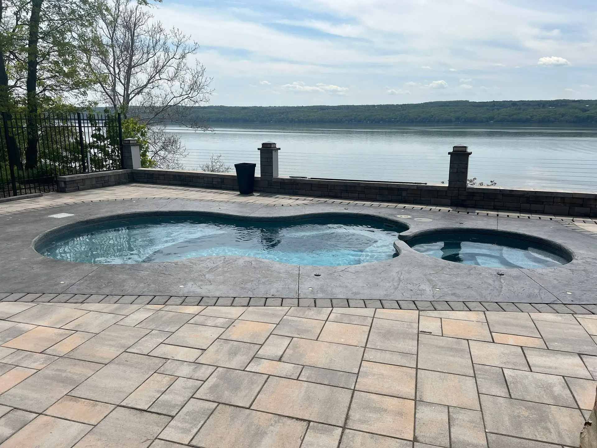 Backyard pool beside a lake