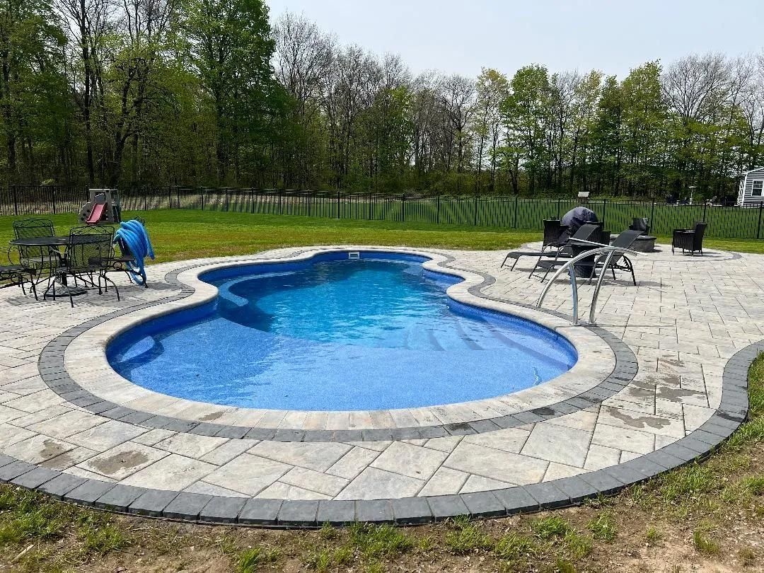 Kidney-shaped pool with stone deck