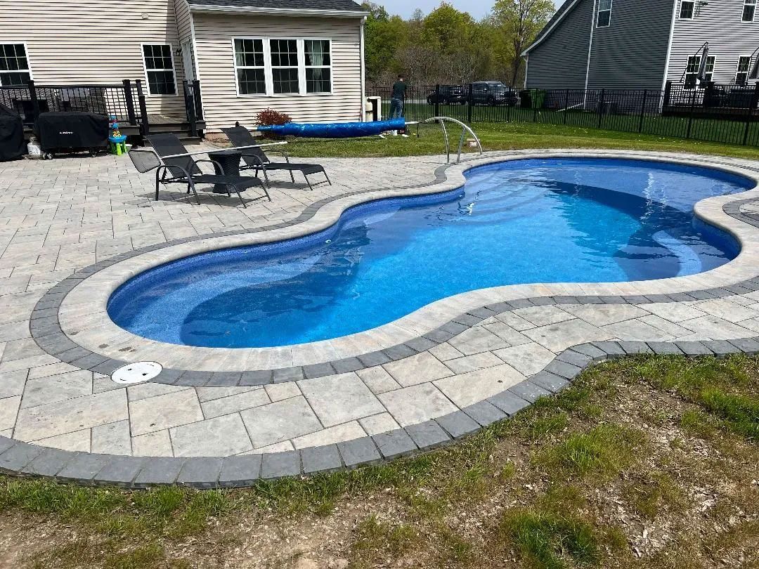 Backyard kidney-shaped pool with blue water