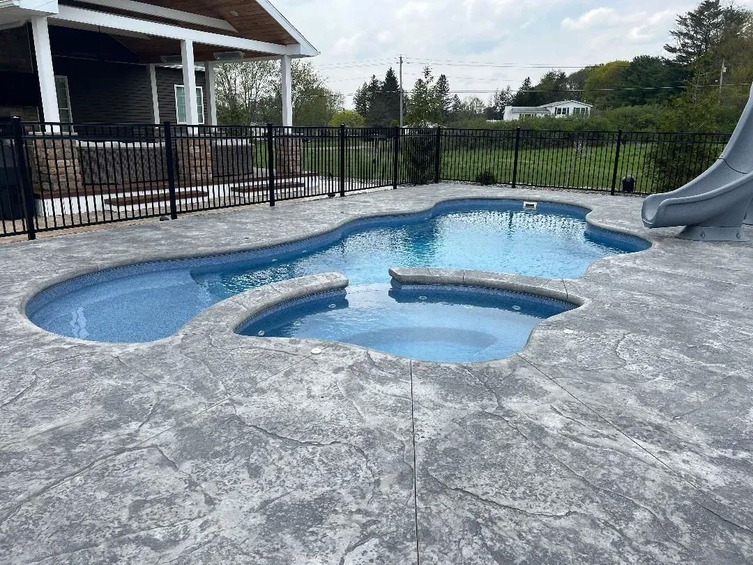  Backyard pool with attached spa and a slide