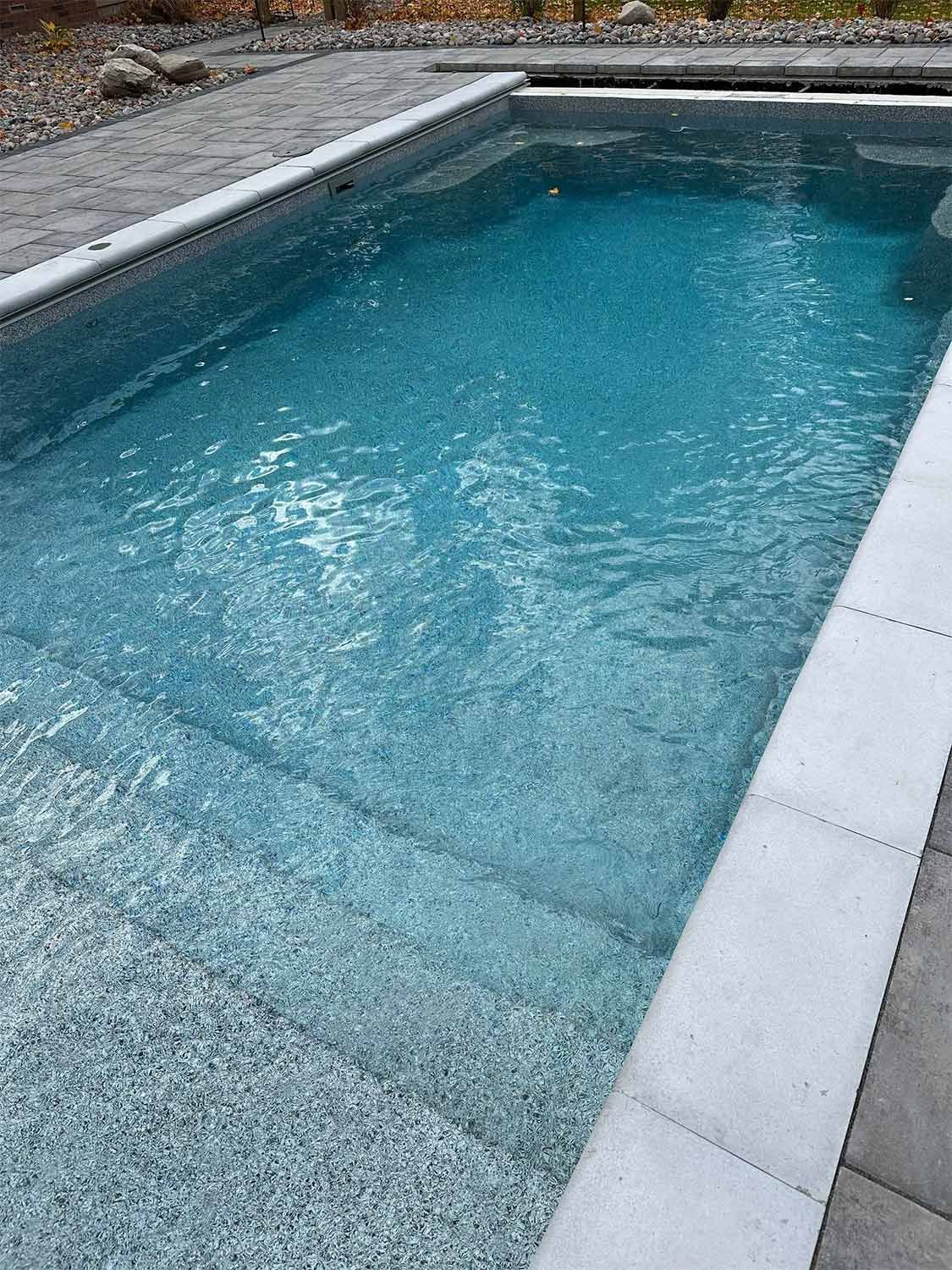 Pool with clean water and white stone coping