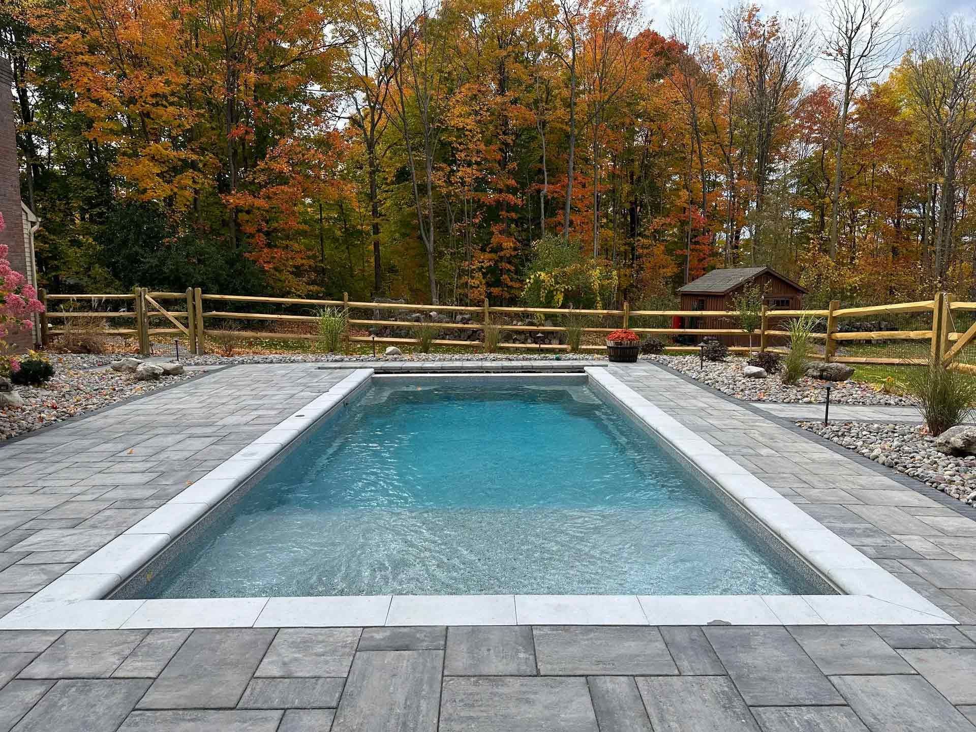 Rectangular outdoor pool with stone deck