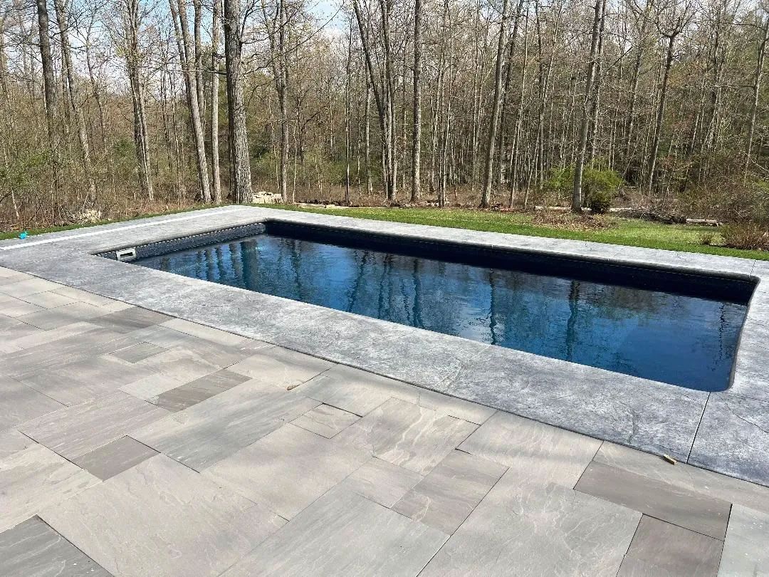 Swimming pool surrounded by stone patio