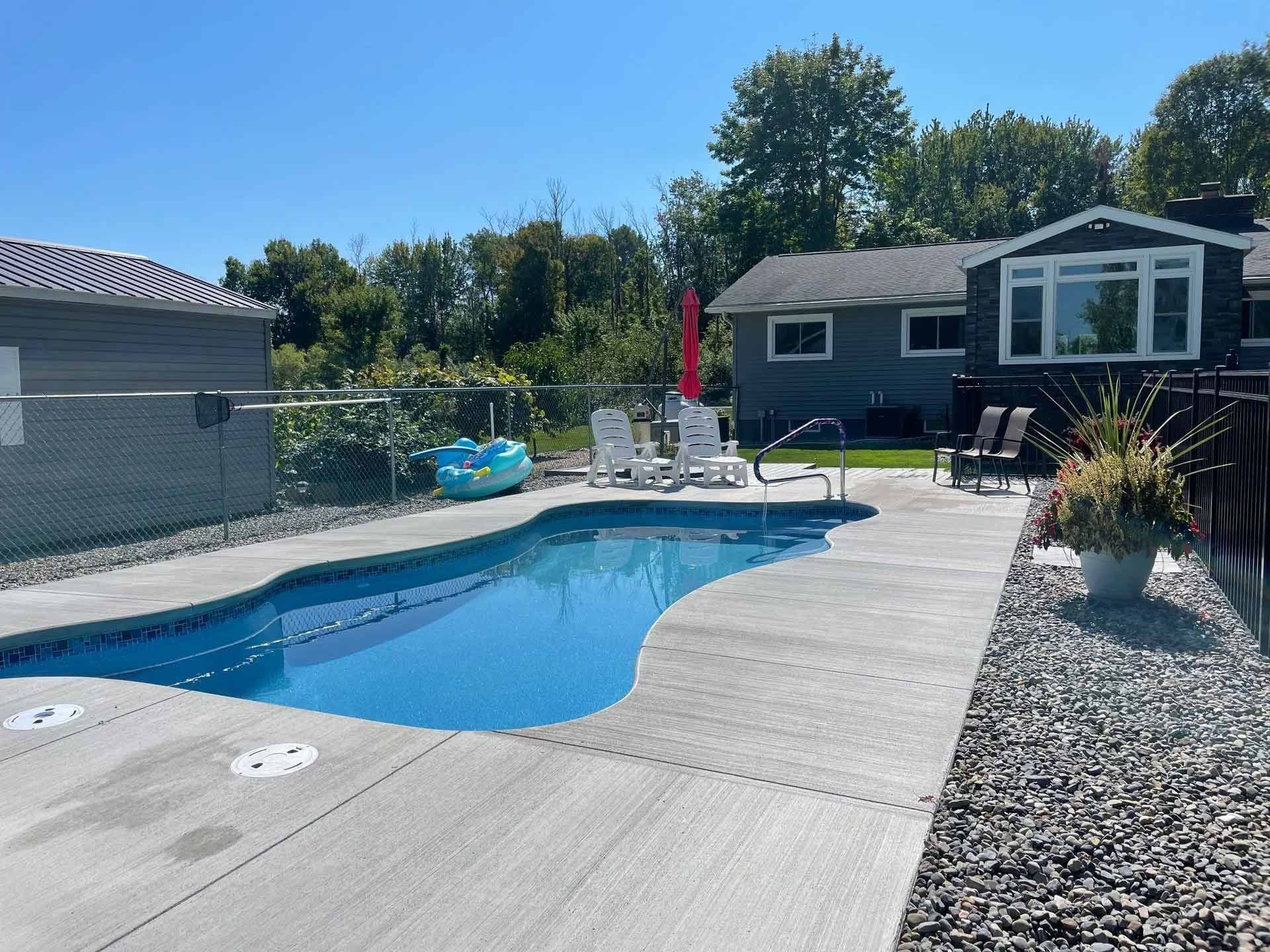Outdoor swimming pool with concrete deck
