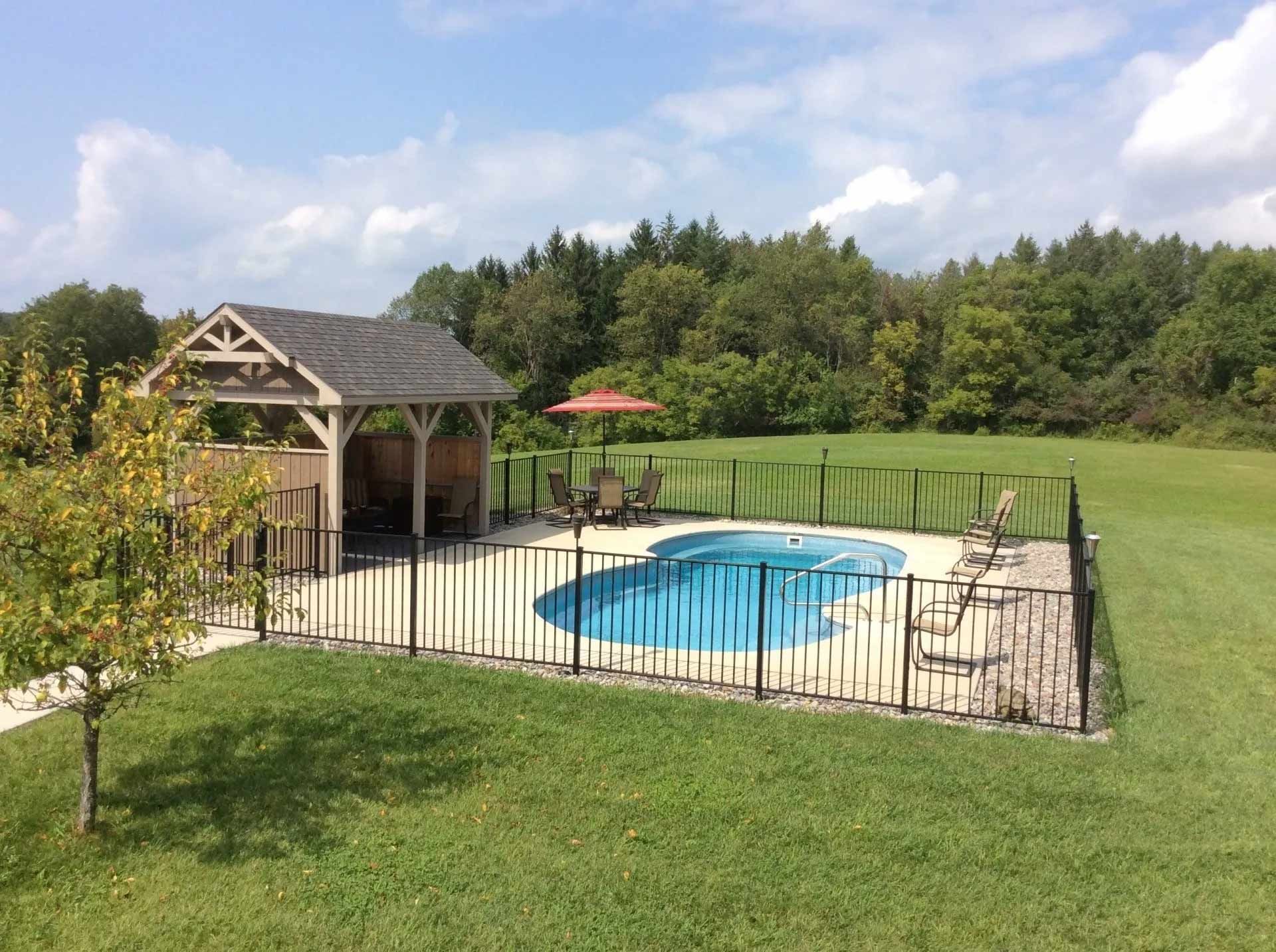 Backyard pool with fenced deck
