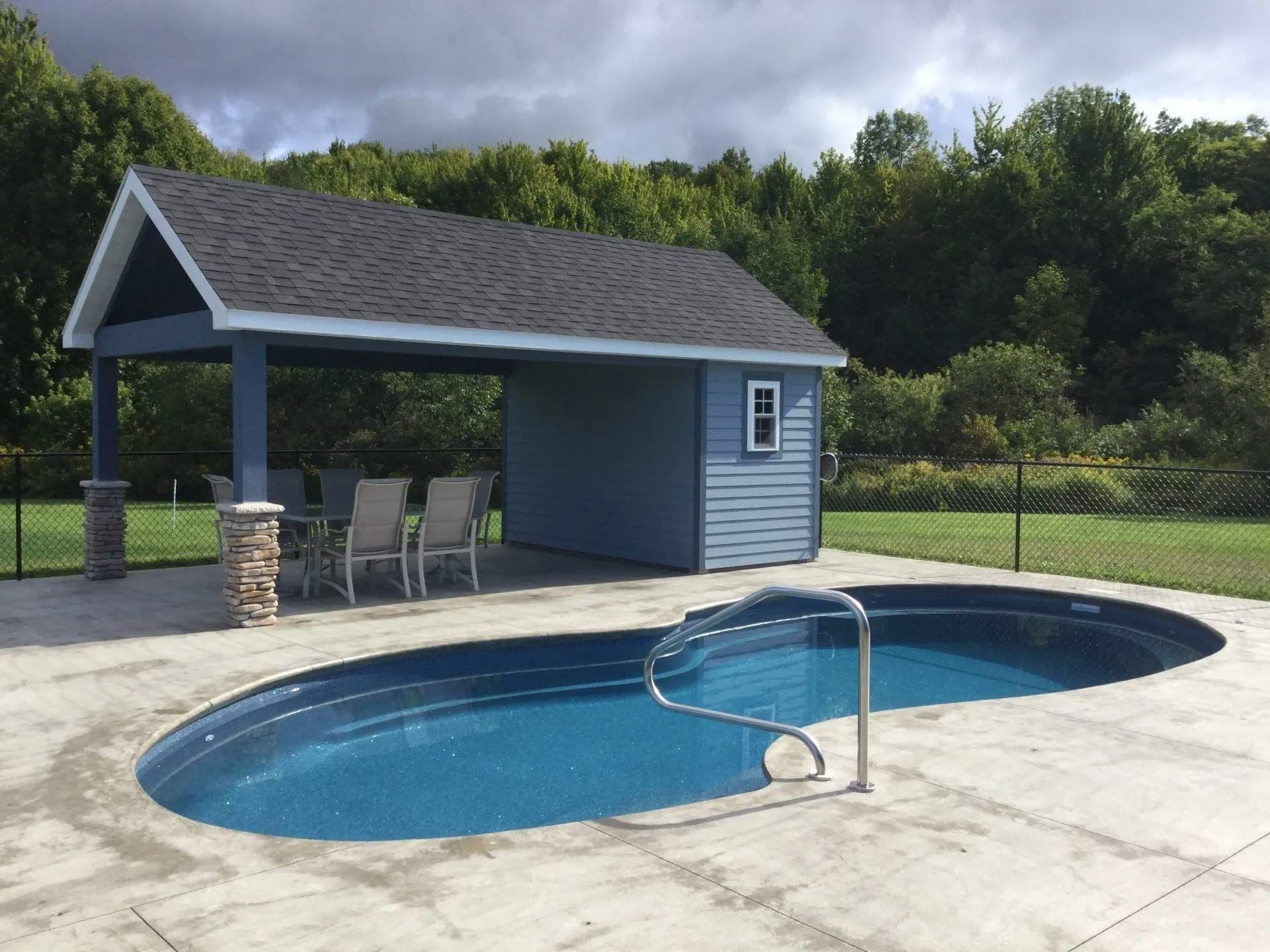 Outdoor pool with blue water and concrete deck