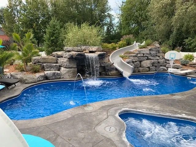 Backyard pool with rock waterfall and slide
