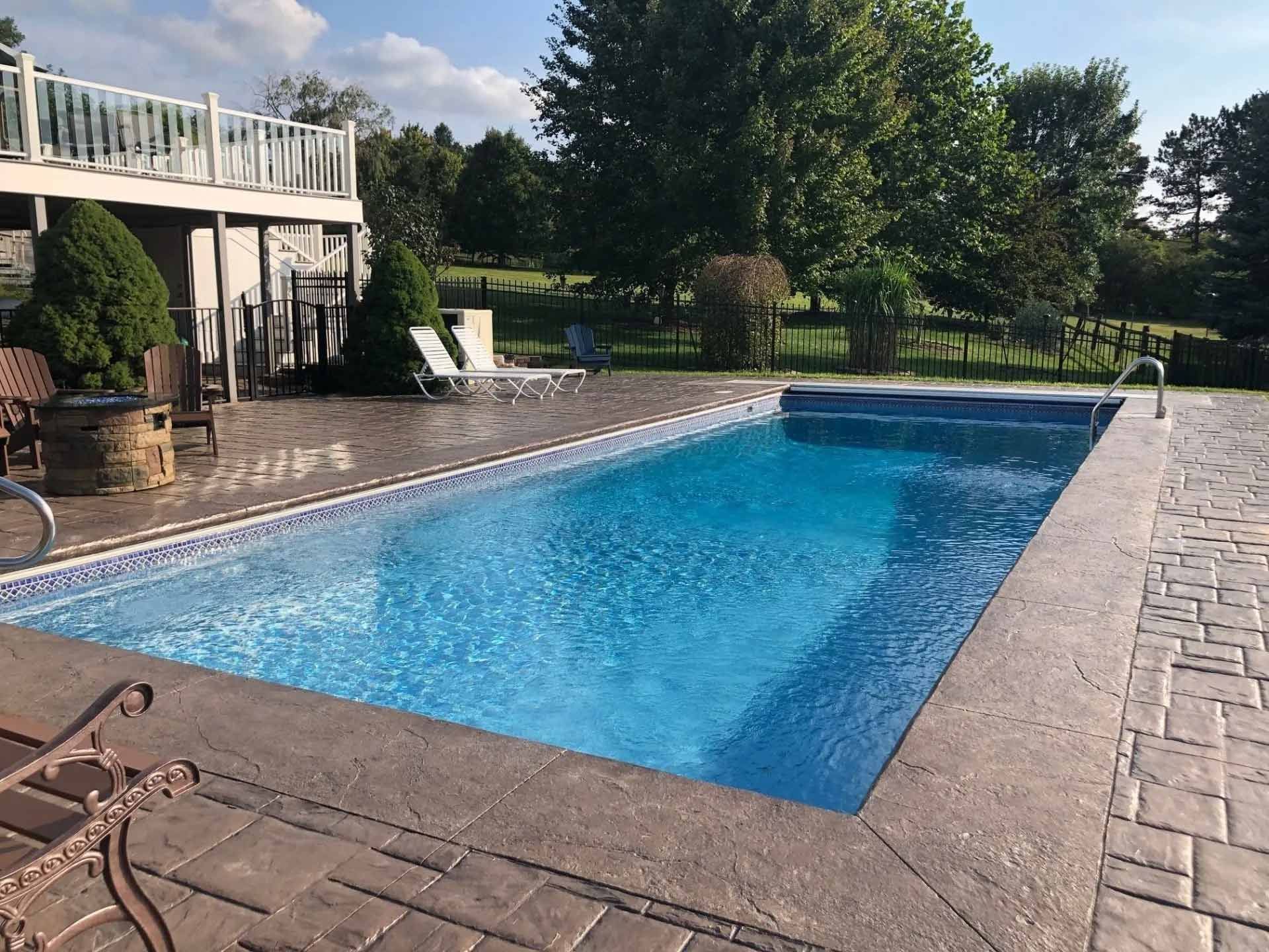 Backyard swimming pool and elevated deck