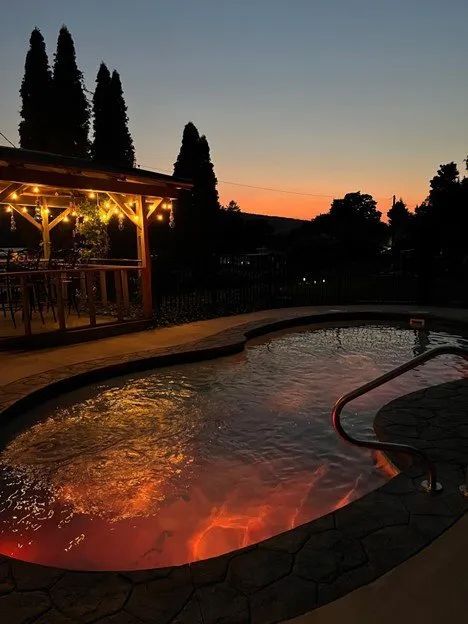 Glowing swimming pool under a sunset