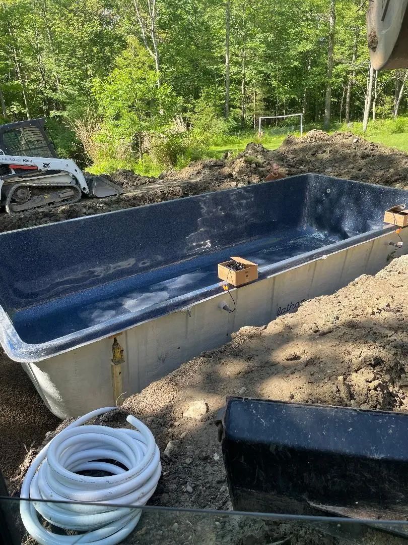 Fiberglass pool shell in a backyard